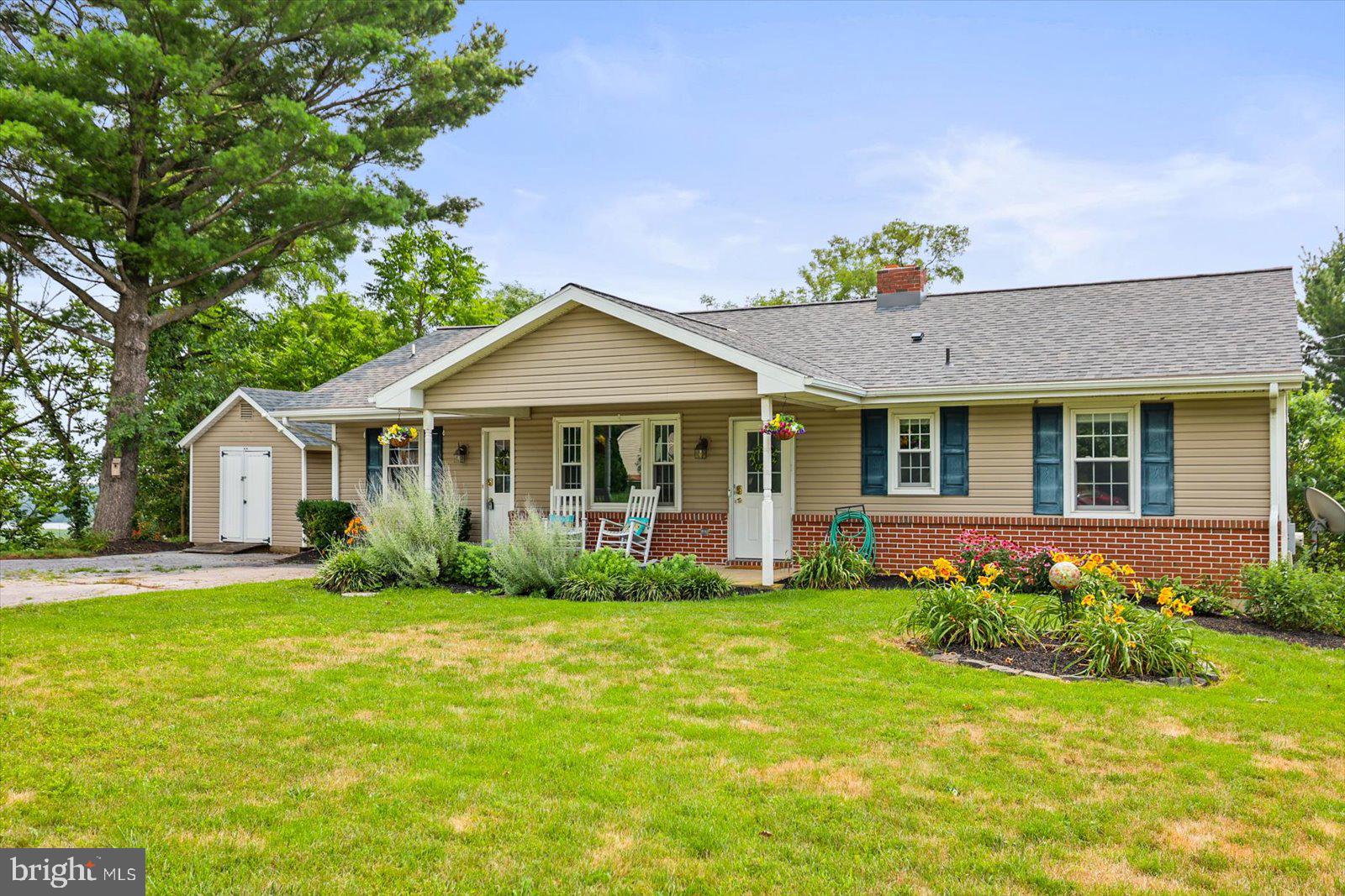 a view of a house with a big yard and potted plants