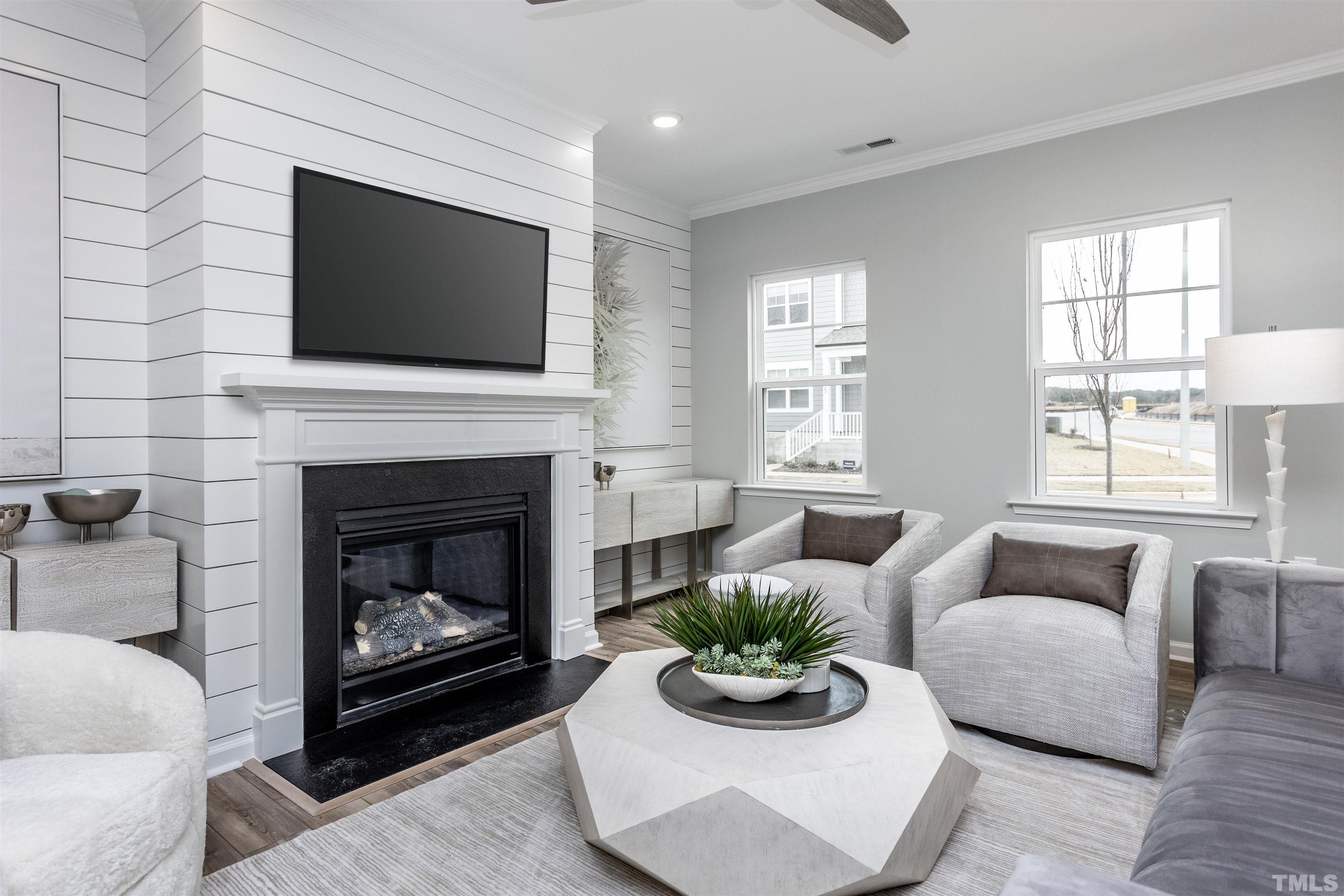4808 Megara Run Raleigh, NC 27603 - Photo 5 of 23 a living room with furniture a flat screen tv and a fireplace