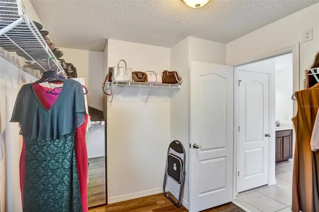 a view of walk in closet with clothes and shoes
