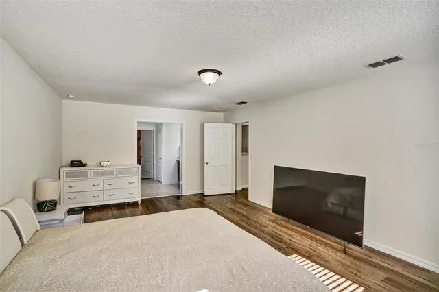 a bedroom with furniture and flat screen tv