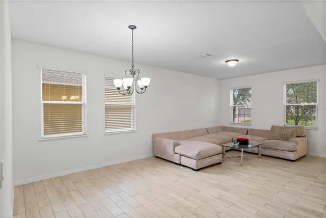 a living room with furniture and a chandelier