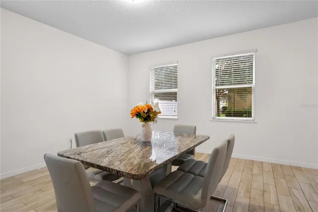 a view of a dining room with furniture and wooden floor