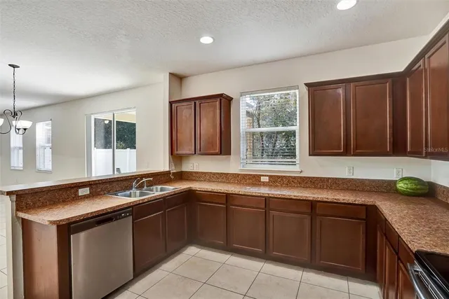 a kitchen that has a sink and a stove in it