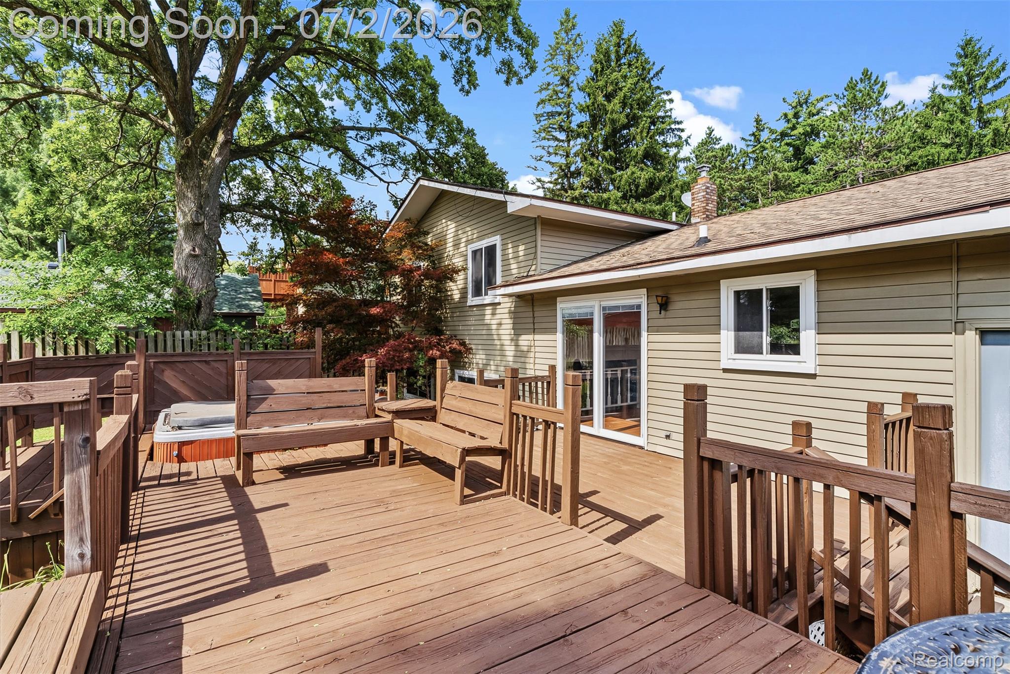 305 East Road Holly, MI 48442 - Photo 35 of 41 Expansive multi-level wood deck featuring integrated benches, privacy panels, and a hot tub