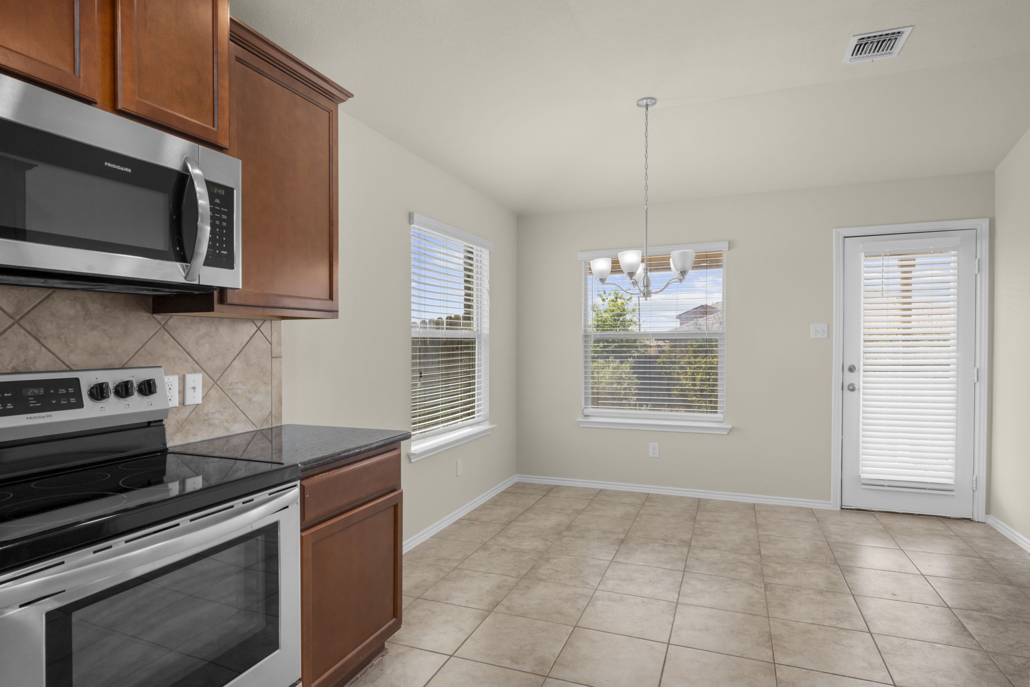 101 Plata Lane Jarrell, TX 76537 - Photo 20 of 27 a kitchen with a stove and a microwave