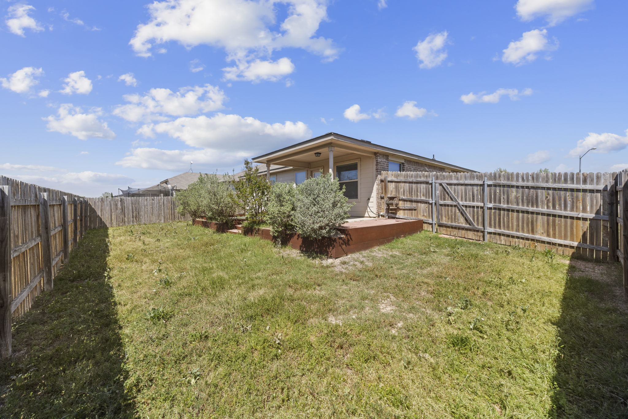 101 Plata Lane Jarrell, TX 76537 - Photo 27 of 27 a view of a garden with a house in the background
