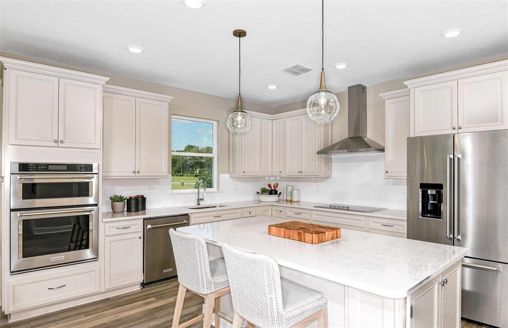 1730 Ruby Ln Lake Lake Alfred, FL 33850 - Photo 4 of 26 a kitchen with refrigerator cabinets and wooden floor