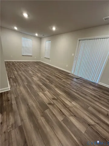 an empty room with wooden floor