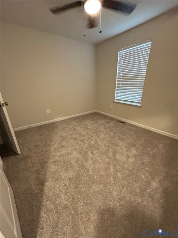 16040 Abelson Way, Unit 16040 Chesterfield, VA 23832 - Photo 11 of 20 an empty room with a chandelier fan and windows