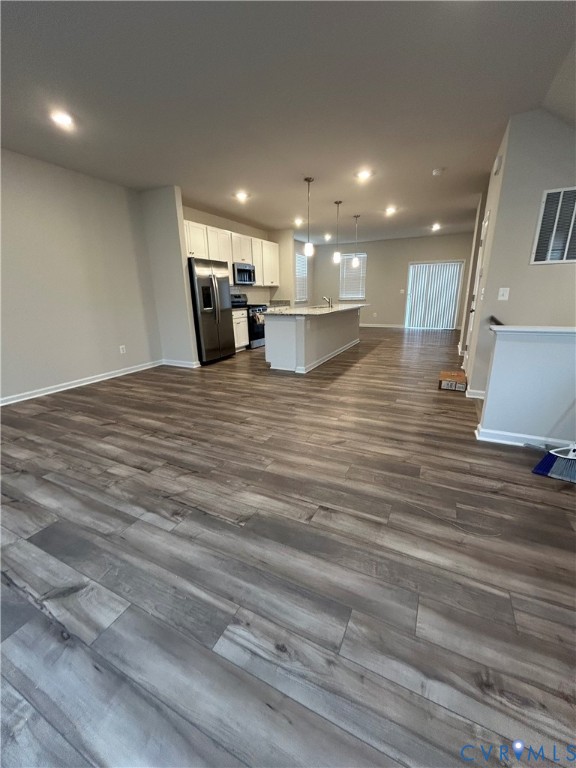 16040 Abelson Way, Unit 16040 Chesterfield, VA 23832 - Photo 20 of 20 a view of kitchen and empty room with wooden floor