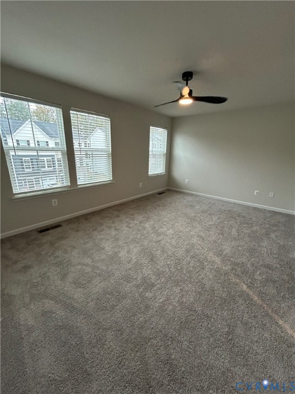 16040 Abelson Way, Unit 16040 Chesterfield, VA 23832 - Photo 18 of 20 en empty room with windows and ceiling fan view