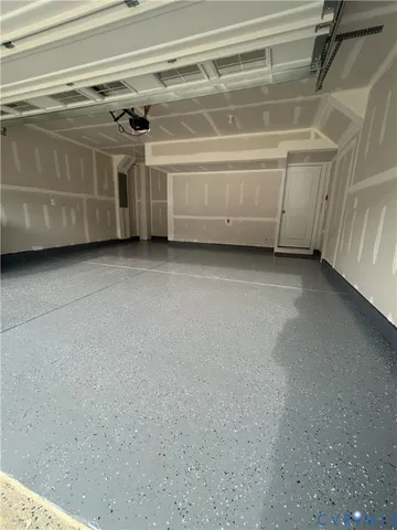 a view of kitchen with kitchen island granite countertop a stove top oven a sink and a refrigerator
