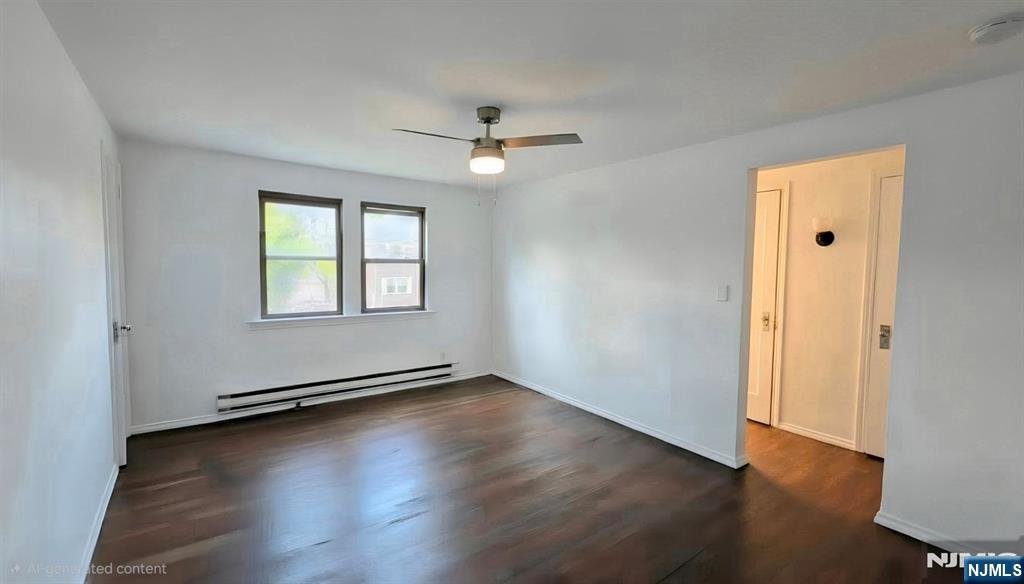 592 Beverly Road, Unit 2 Teaneck, NJ 07666 - Photo 2 of 7 an empty room with wooden floor chandelier fan and windows