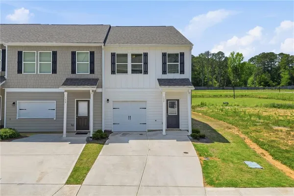 a front view of a house with a yard