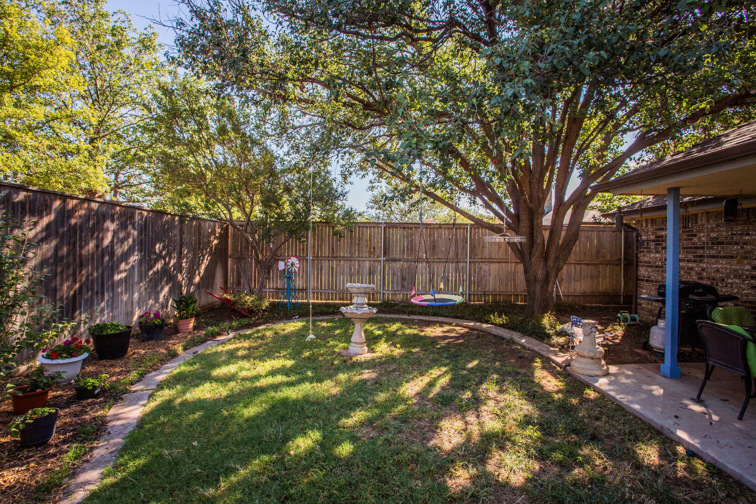 6030 72nd Street Lubbock, TX 79424 - Photo 31 of 33 a backyard of a house with table and chairs