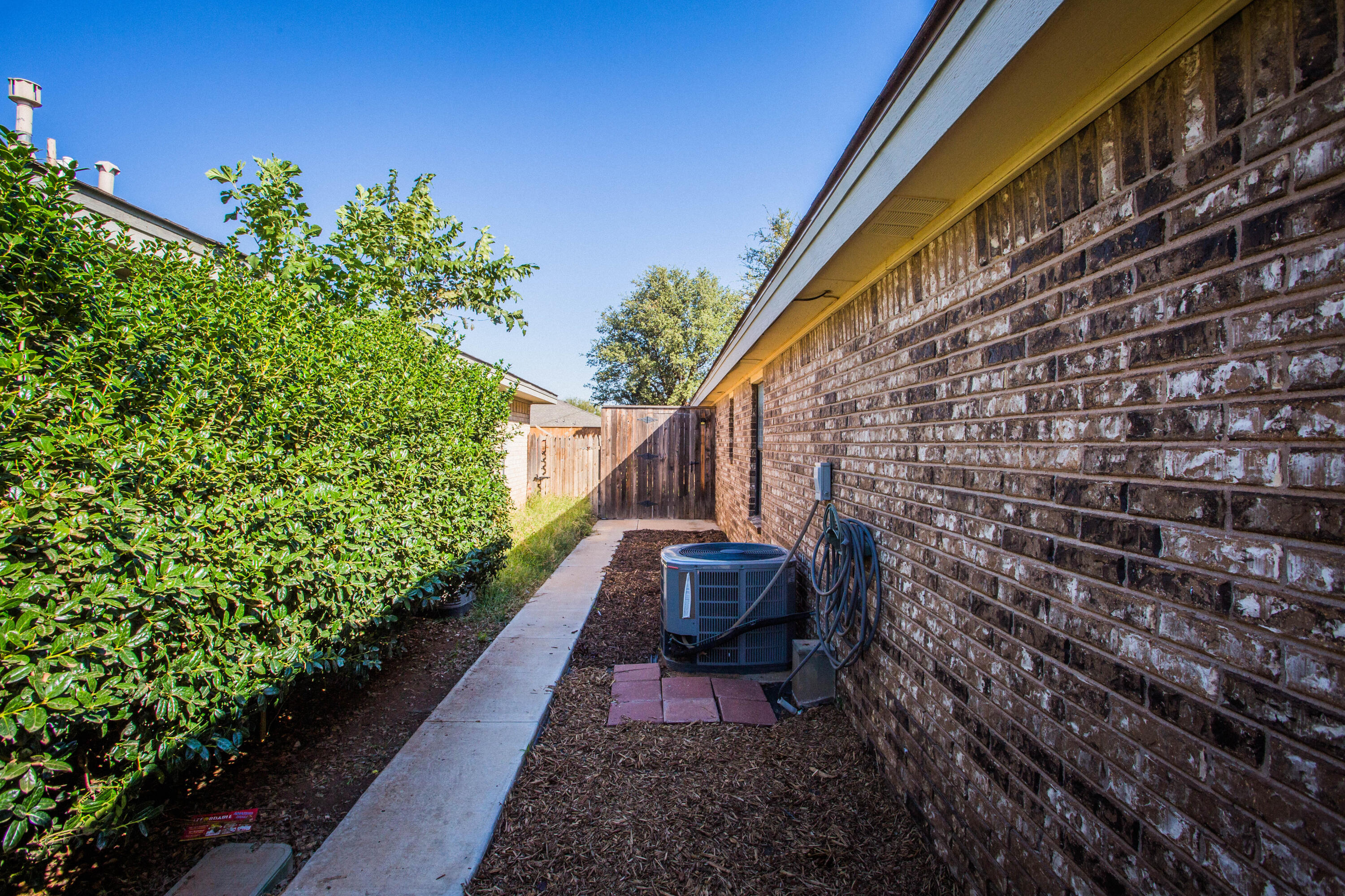 6030 72nd Street Lubbock, TX 79424 - Photo 32 of 33 a pathway of a house with wooden fence