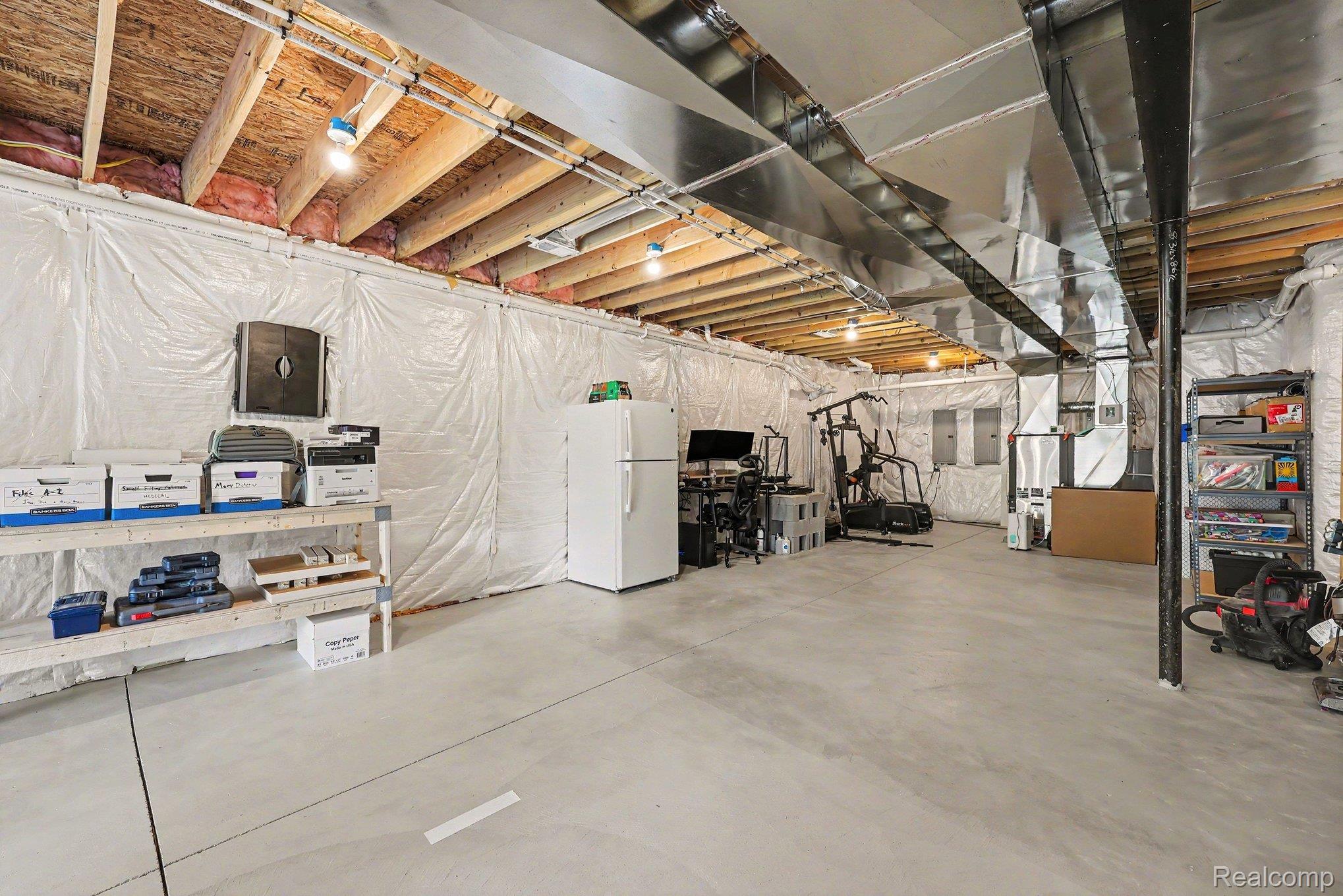 1660 Winthrop Road Bloomfield Hills, MI 48302 - Photo 30 of 38 Unfinished basement featuring exposed wood joists, concrete flooring, insulated walls, and overhead ductwork