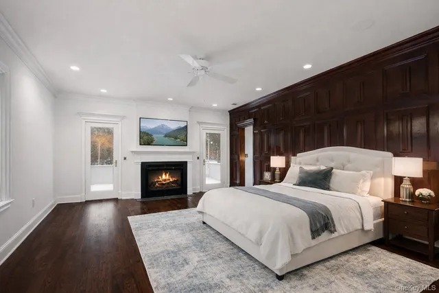 a bedroom with a large bed and a fireplace