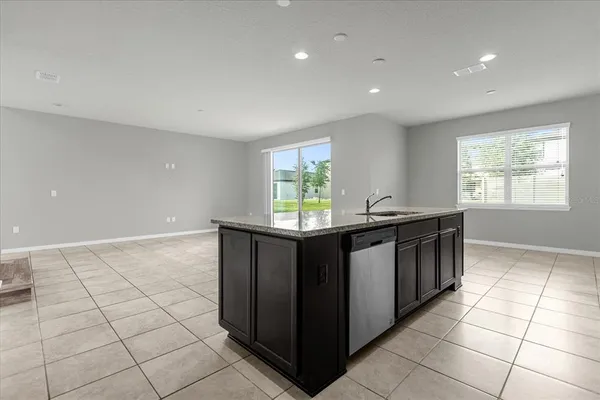 a kitchen with stainless steel appliances granite countertop a sink and a white cabinets
