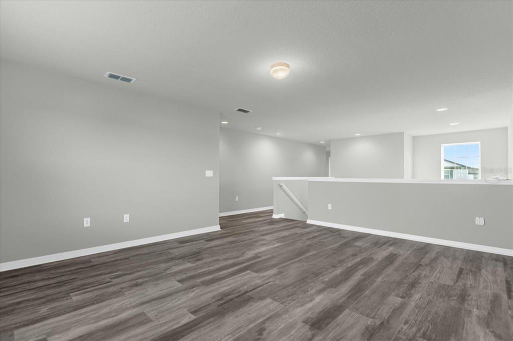 3504 Southern Cross Loop Kissimmee, FL 34744 - Photo 14 of 27 a view of an empty room with wooden floor