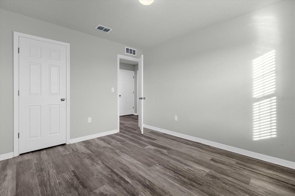 3504 Southern Cross Loop Kissimmee, FL 34744 - Photo 17 of 27 a view of an empty room with wooden floor and a window