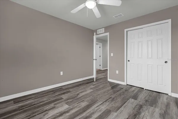 a view of an empty room with wooden floor