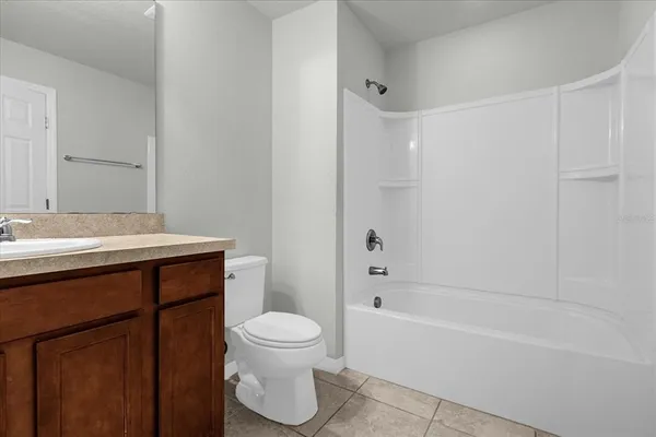a bathroom with a sink a toilet and bathtub