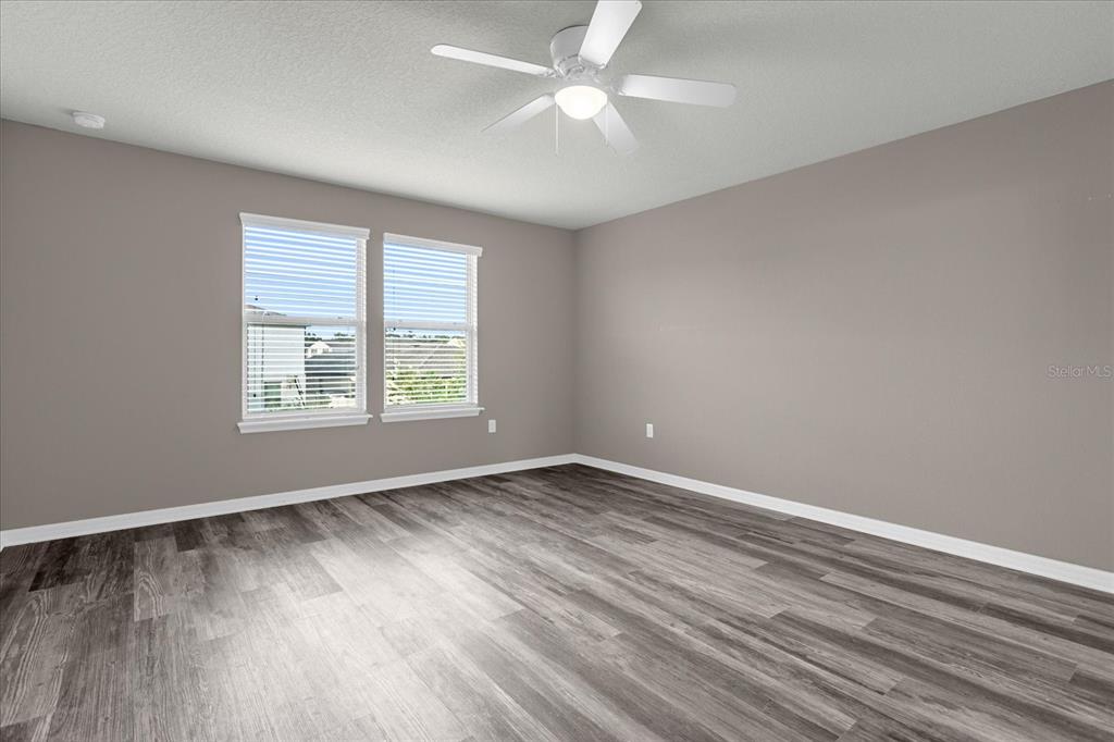 3504 Southern Cross Loop Kissimmee, FL 34744 - Photo 22 of 27 wooden floor in an empty room with a window