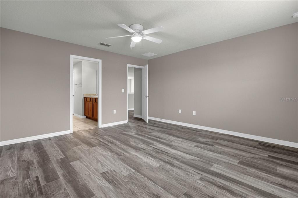 3504 Southern Cross Loop Kissimmee, FL 34744 - Photo 23 of 27 a view of an empty room with wooden floor and a ceiling fan
