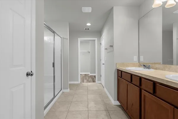 a bathroom with a double vanity sink and mirror