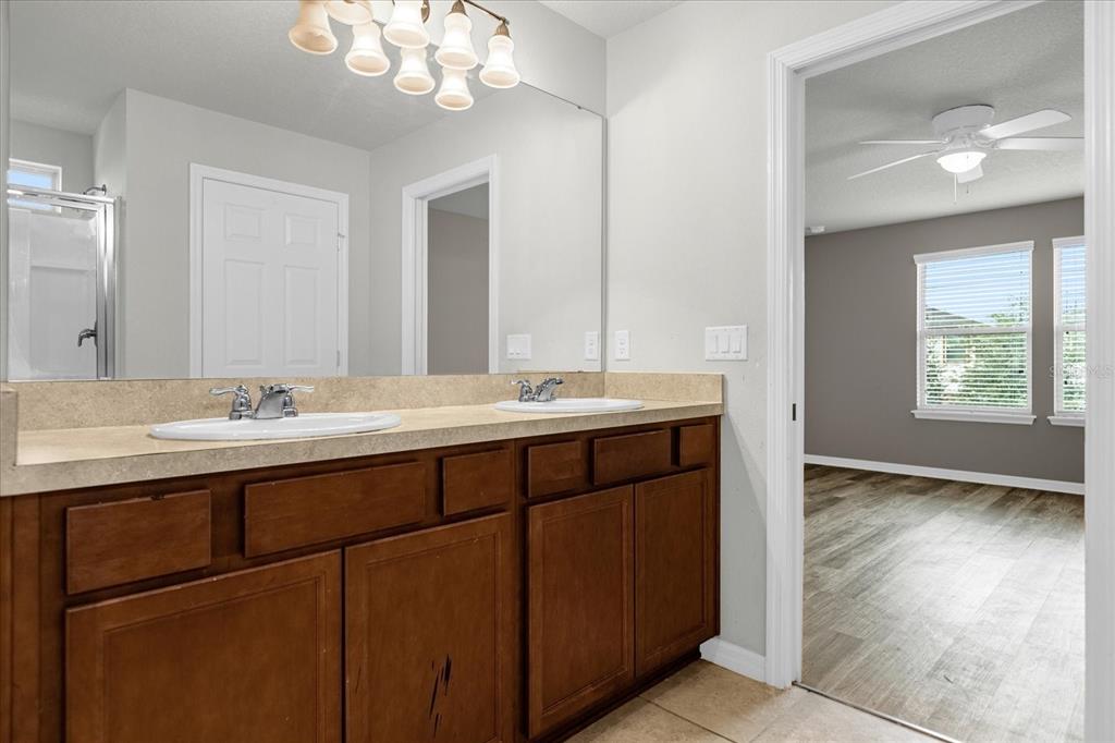 3504 Southern Cross Loop Kissimmee, FL 34744 - Photo 26 of 27 a bathroom with a sink double vanity and a mirror