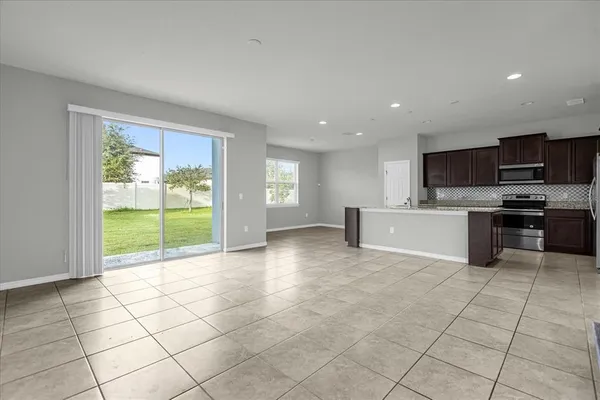 a view of a kitchen with microwave and refrigerator