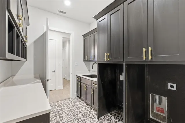 a kitchen with stainless steel appliances granite countertop a refrigerator a sink and dishwasher