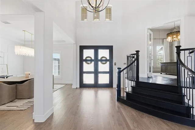a view of entryway and hall with wooden floor