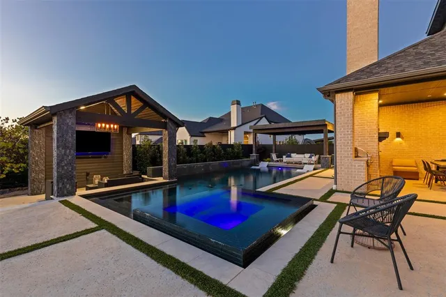 a view of a house with swimming pool and sitting area