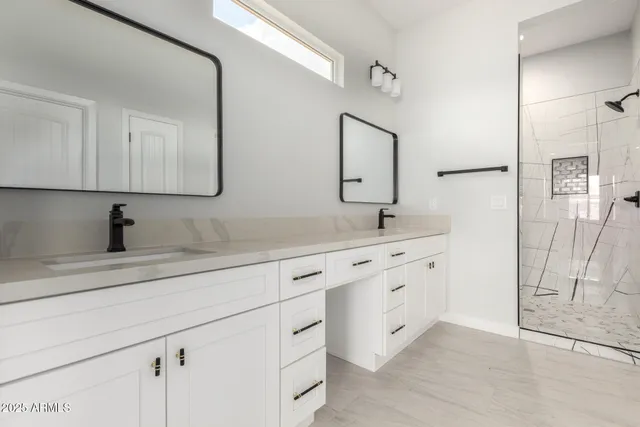 a bathroom with double sink and a mirror