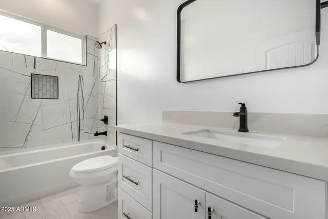 a bathroom with a sink a toilet and a bathtub