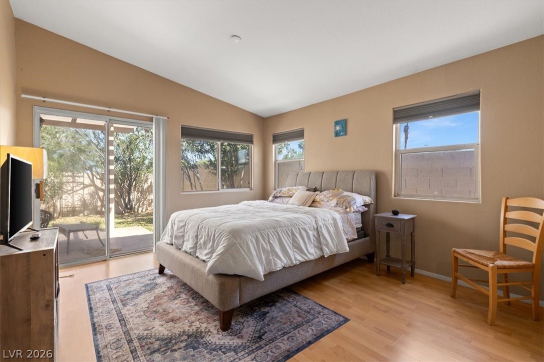2377 Ramsgate Drive Henderson, NV 89074 - Photo 13 of 25 Natural light floods this inviting bedroom with vaulted ceilings and outdoor access.