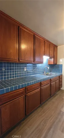 a kitchen with wooden cabinets a sink and dishwasher