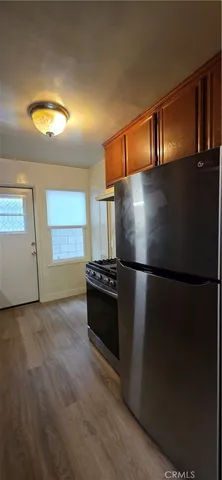 a view of kitchen with refrigerator and window