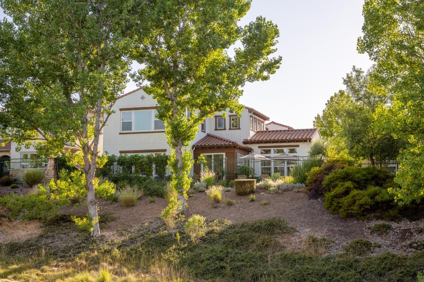 7680 MacKenzie Way Gilroy, CA 95020 - Photo 53 of 61 a front view of a house with a yard and trees