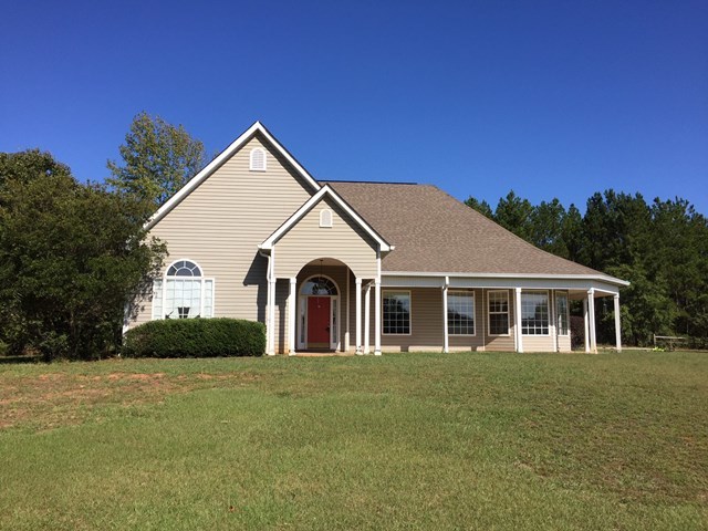 409 Torbet Road, Unit 1A1 Forsyth, GA 31029 - Photo 1 of 29 a front view of a house with a garden
