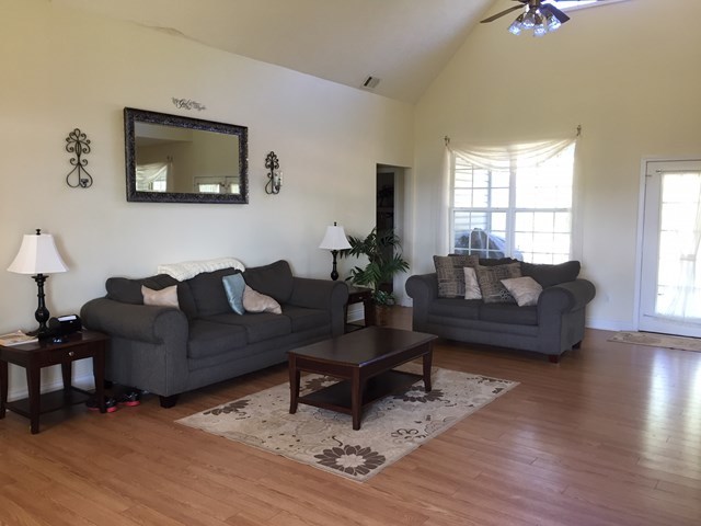 409 Torbet Road, Unit 1A1 Forsyth, GA 31029 - Photo 2 of 29 a living room with furniture and a wooden floor