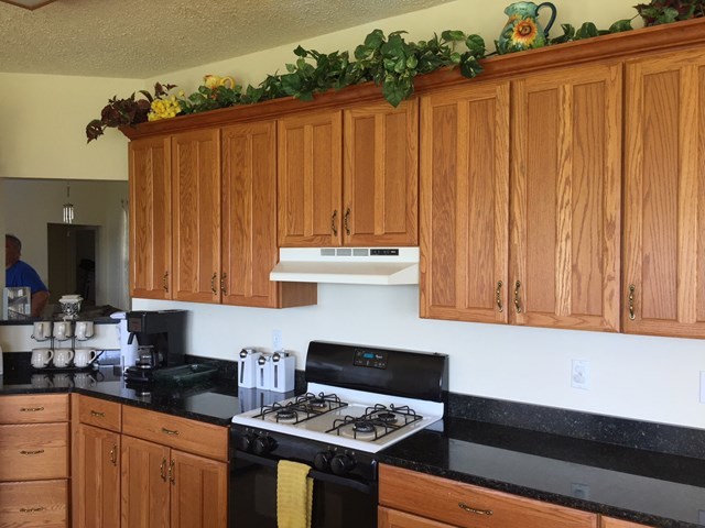 409 Torbet Road, Unit 1A1 Forsyth, GA 31029 - Photo 11 of 29 a kitchen with kitchen island a sink cabinets and appliances