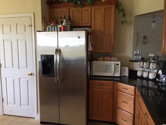409 Torbet Road, Unit 1A1 Forsyth, GA 31029 - Photo 12 of 29 a kitchen with stainless steel appliances a refrigerator and cabinets