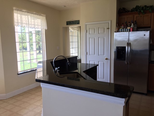 409 Torbet Road, Unit 1A1 Forsyth, GA 31029 - Photo 14 of 29 a kitchen with a refrigerator and a sink