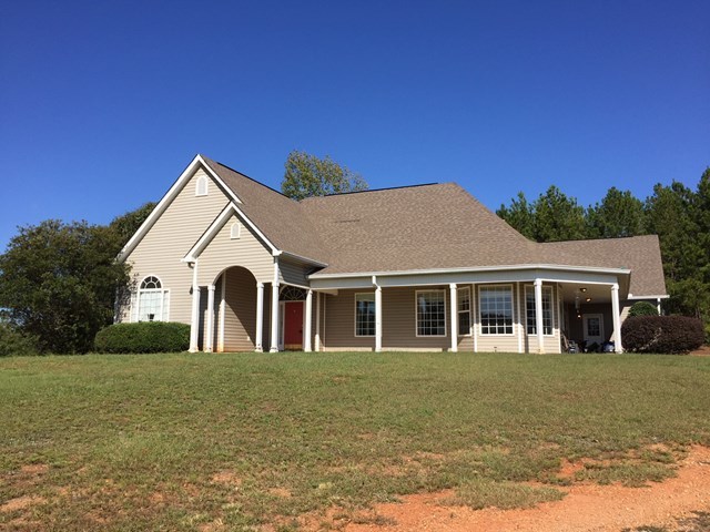 409 Torbet Road, Unit 1A1 Forsyth, GA 31029 - Photo 17 of 29 a front view of a house with a yard