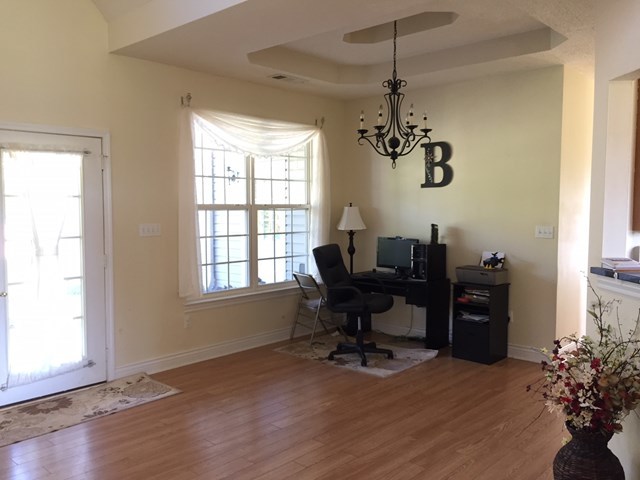 409 Torbet Road, Unit 1A1 Forsyth, GA 31029 - Photo 3 of 29 a view of a dining room with furniture window and wooden floor