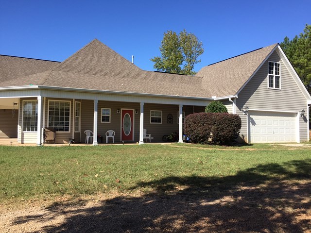 409 Torbet Road, Unit 1A1 Forsyth, GA 31029 - Photo 21 of 29 a front view of a house with a garden and yard