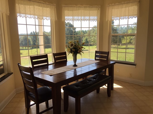 409 Torbet Road, Unit 1A1 Forsyth, GA 31029 - Photo 9 of 29 a view of a dining room with a table and chairs